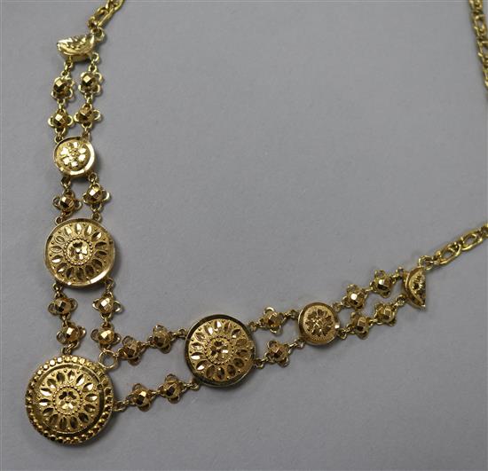 A yellow metal (tests as 14ct) disc necklace, comprising five graduated floral-engraved discs on 9ct gold suspension